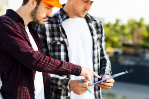 Close-up of mining inspectors reviewing a checklist, illustrating effective task training under MSHA Part 46.